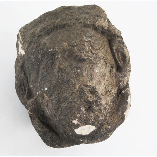A medieval carved stone corbel in the form of a man's head. 20cm high.
