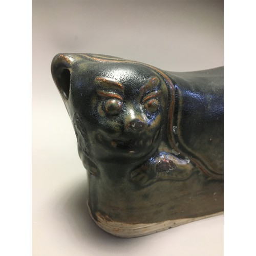 100 - Chinese - AN EARLY CHINESE BLACK GLAZED POTTERY PILLOW possibly Tang Dynasty, formed as a recumbent ... 