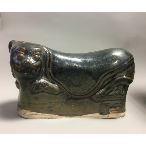 100 - Chinese - AN EARLY CHINESE BLACK GLAZED POTTERY PILLOW possibly Tang Dynasty, formed as a recumbent ... 