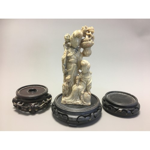 109 - Chinese Carved Soapstone Figural Group of Guayin and Attendant on an unassociated Carved wooden Stan... 