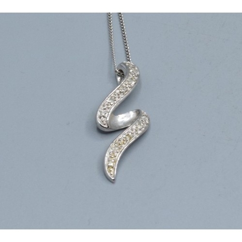 2512 - 9ct white gold Diamond scroll pendant necklace hallmarked as Diamond on a 9ct white gold neck chain ... 