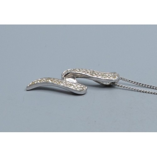 2512 - 9ct white gold Diamond scroll pendant necklace hallmarked as Diamond on a 9ct white gold neck chain ... 