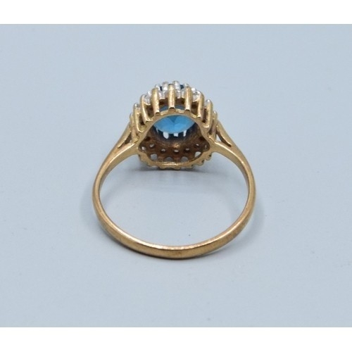 2515 - Vintage 9ct gold ladies Aquamarine and oval halo cluster ring held in a claw setting with the head b... 