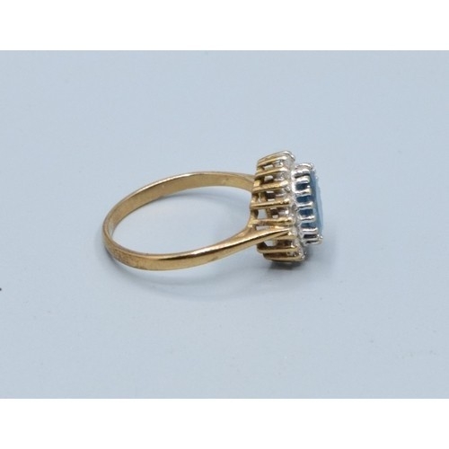 2515 - Vintage 9ct gold ladies Aquamarine and oval halo cluster ring held in a claw setting with the head b... 