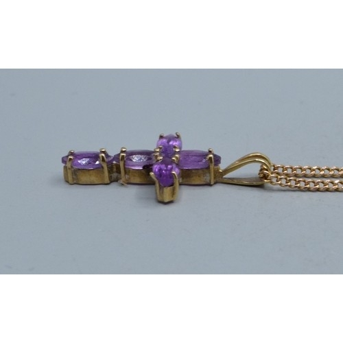 2553 - 9ct gold Amethyst cross measuring 2.3x1.3cm including the bale on a 9ct gold neck chain of 52cm long... 
