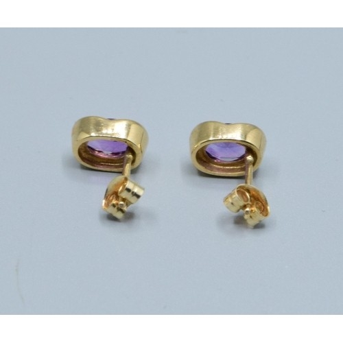 2563 - Pair 9ct gold Amethyst stud earrings in an enclosed setting Amethyst measures 9x6mm