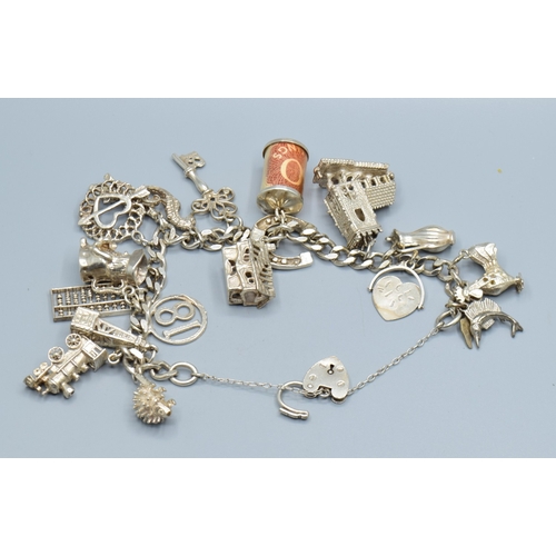 2589 - Ladies 925 silver charm bracelet with padlock catch and safety chain, together with 15 charms to inc... 