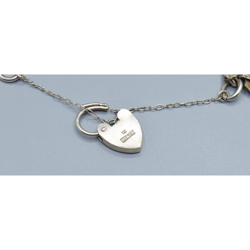 2589 - Ladies 925 silver charm bracelet with padlock catch and safety chain, together with 15 charms to inc... 