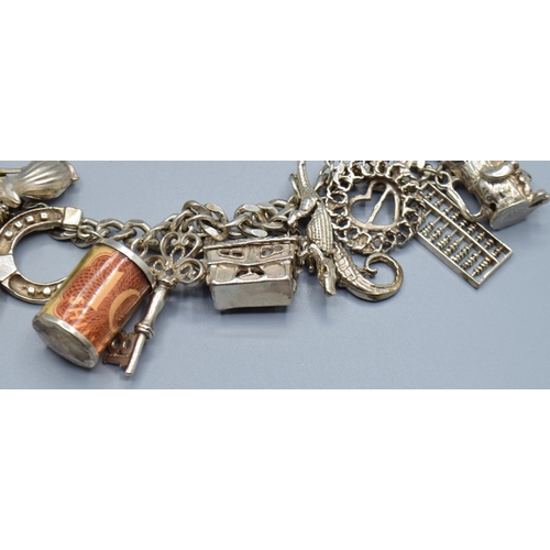 2589 - Ladies 925 silver charm bracelet with padlock catch and safety chain, together with 15 charms to inc... 