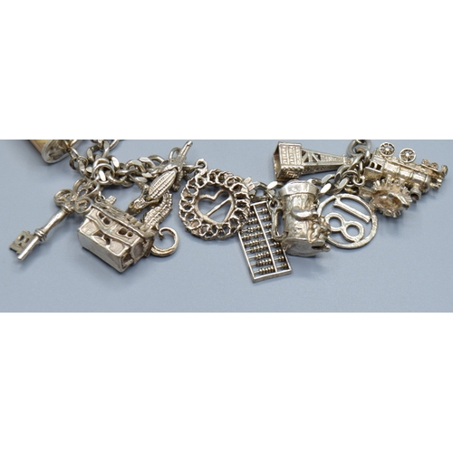 2589 - Ladies 925 silver charm bracelet with padlock catch and safety chain, together with 15 charms to inc... 