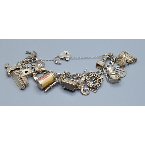 2589 - Ladies 925 silver charm bracelet with padlock catch and safety chain, together with 15 charms to inc... 