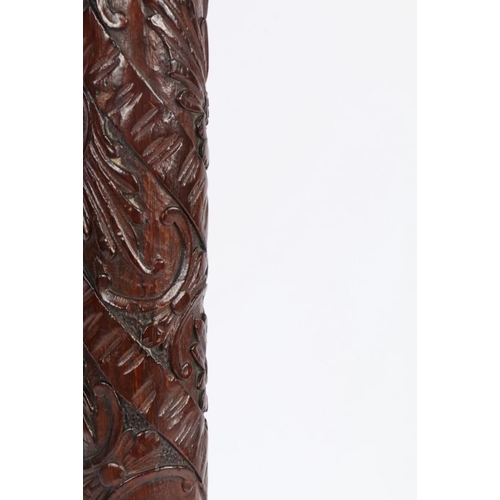 10 - Chinese carved hardwood standard lamp, the tapering column carved with flower heads, raised on trifo... 