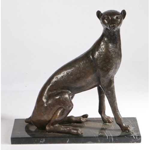 118 - 20th Century bronze leopard, modelled in a seated position, on a black veined marble base, 37cm wide... 