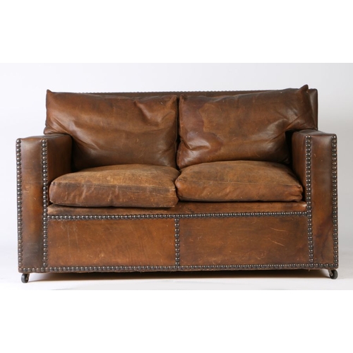 151 - 1920's brown leather club style settee, with studded upholstery, loose back and seat cushions, 135cm... 