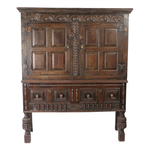 158 - 17th Century and later oak cupboard, the stepped pediment above a foliate and arch carved frieze, tw... 