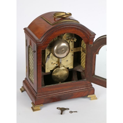 188 - George III mahogany mantel clock, Dwerrihouse & Carter, London, the arched caddy top with brass fitt... 