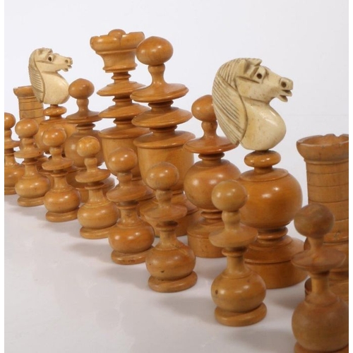 24 - A Regence pattern chess set, French late 19th century, turned boxwood and ebony pieces with carved b... 