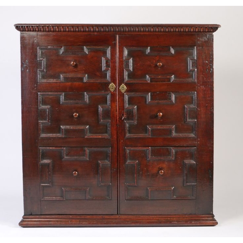 243 - 18th Century and later oak cupboard, with two geometric moulded panel cupboard doors opening to reve... 