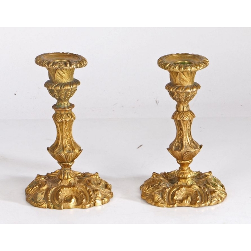 246 - Pair of 19th century Rococo style ormolu candlesticks, with gadrooned sconces, acanthus leaf and scr... 