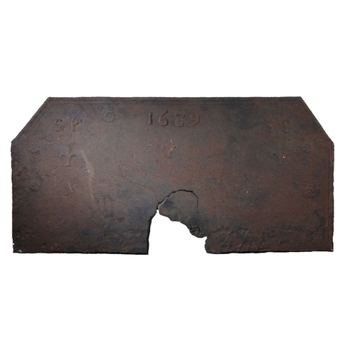 269 - A large William & Mary iron fire back, dated 1689

 The rectangular back with canted corners, upper ... 