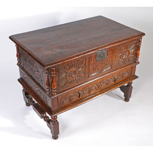 5 - 17th century and later chest on stand, the hinged lid above a foliate carved front panel, initialled... 