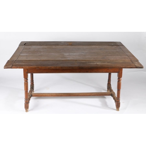 54 - An early 18th century oak draw-leaf table, French, circa 1730

 Having a triple boarded and end-clea... 