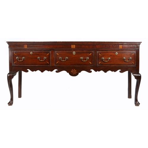 24 - A George III oak and inlaid low dresser, North-West/West Midlands, circa 1780

The top of two wide b... 