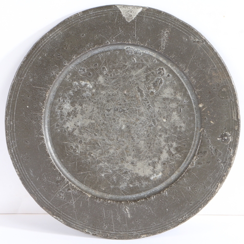 113 - A rare Charles II pewter paten, circa 1680

 With broad incised multiple reeded rim, and flat well, ... 
