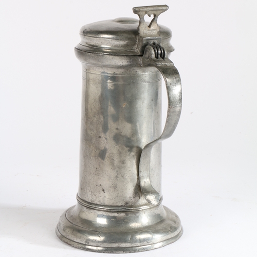 126 - A Charles I pewter flagon, circa 1640

 Having a tapering straight-sided drum with paired incised li... 