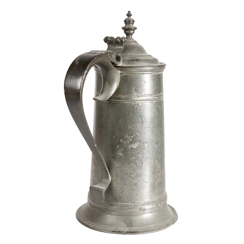 28 - A George I pewter spire flagon, circa 1715

 The straight-sided tapering drum with a high fillet, an... 