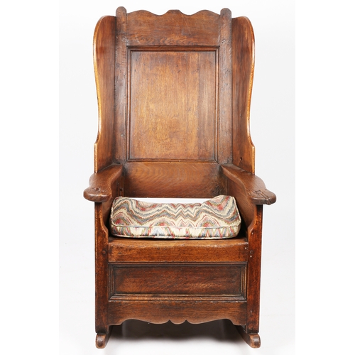 297 - A George I/II oak winged armchair, Welsh, circa 1720-40

 Having a rectangular fielded back with bea... 