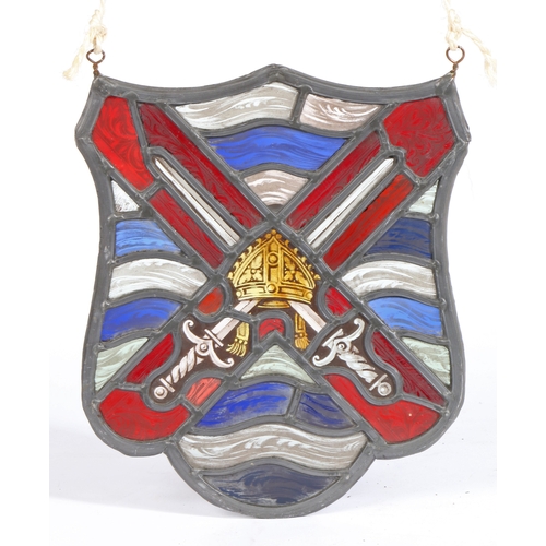 300 - A stained glass panel

 Of shield shape, designed with crossed-swords centred by a bishops mitre, i... 