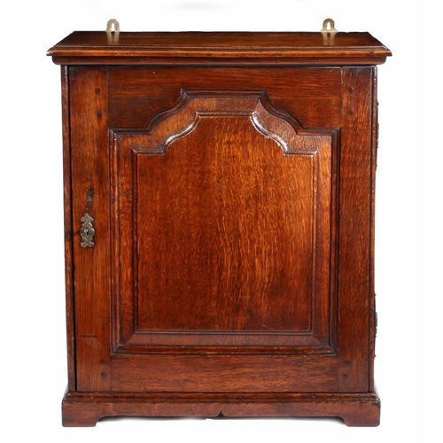 313 - A George II oak table-top spice cupboard, circa 1750 and later

 Having a flattened-ogee arched fiel... 