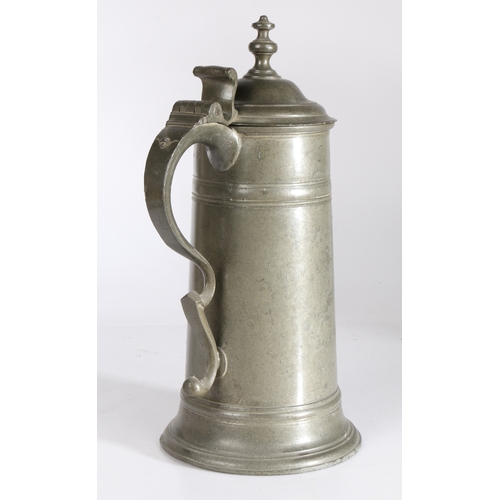 32 - A George I/II pewter spire flagon, circa 1720-50

 Having a straight-sided tapering drum with broad ... 