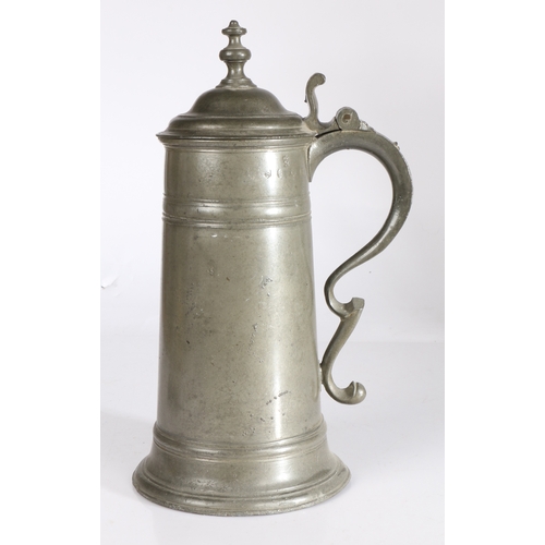 32 - A George I/II pewter spire flagon, circa 1720-50

 Having a straight-sided tapering drum with broad ... 