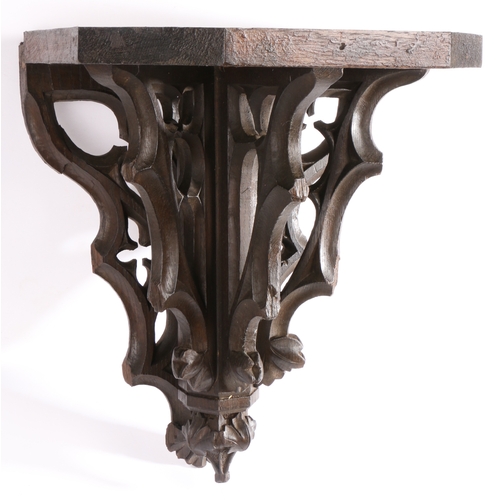 332 - A 19th century carved oak Gothic-Revival bracket, English

 The rectangular top with canted front co... 