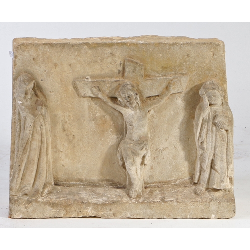 339 - A 17th century carved stone depiction of the Crucifixion

 The central cross and body of Christ flan... 