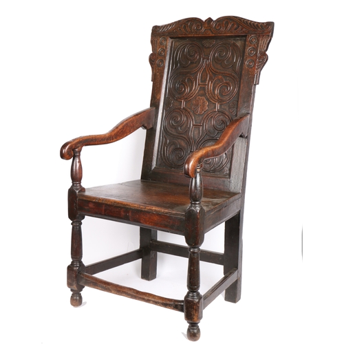 344 - A Charles II oak open armchair, circa 1660 and later

 The back panel relief carved with strap-work ... 