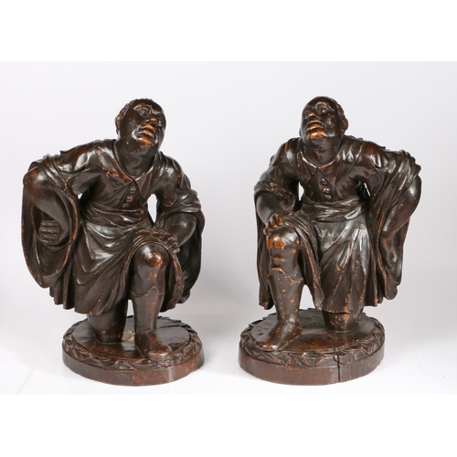 354 - A good pair of 18th century 'ebonised Iimewood blackamoor figures, Italian

 Each designed kneeling... 