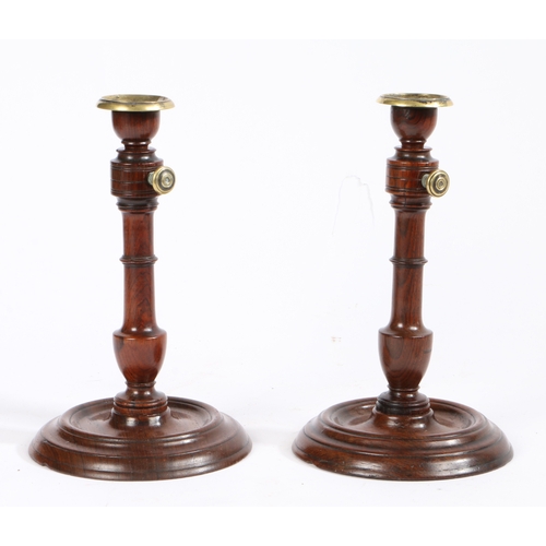 356 - A pair of late George III rosewood and brass candlesticks, circa 1800

 With adjustable height pilla... 