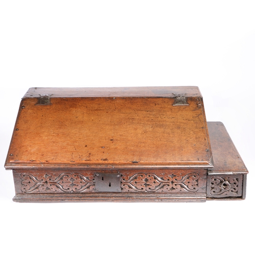 395 - An early 17th century boarded oak desk box, English, circa 1600-30

 Having a one-piece sloping lid ... 