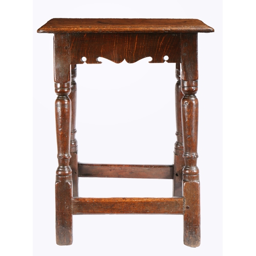 397 - A Charles I oak joint stool, circa 1640

 Having an ovolo-moulded top, bicuspid-shaped rails, on bal... 