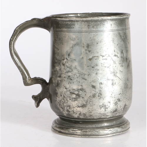 45 - A George II pewter pint U-shaped mug, attributed to Wigan, circa 1740

 Having a simple lip above a ... 