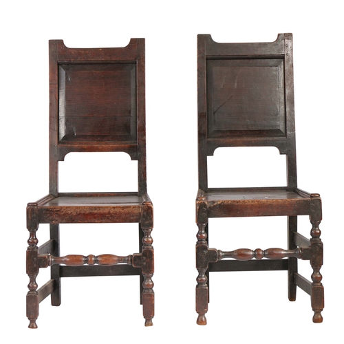 452 - A pair of early 18th century oak backstools, English, circa 1700-20

 Each with a fielded back panel... 