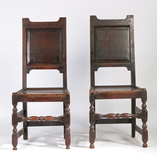 452 - A pair of early 18th century oak backstools, English, circa 1700-20

 Each with a fielded back panel... 