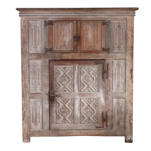 453 - A 16th century style oak livery cupboard, circa 1900 

 In the Wardour Street manner, English, with ... 