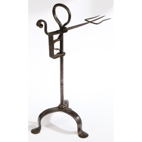 454 - A George III wrought iron standing bird spit, circa 1790

 The fork of three tines, rising and falli... 