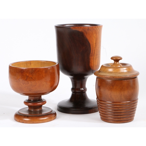 461 - Three items of treen

 To include a lignum vitae goblet with turned baluster stem, 20.5cm high, a tr... 