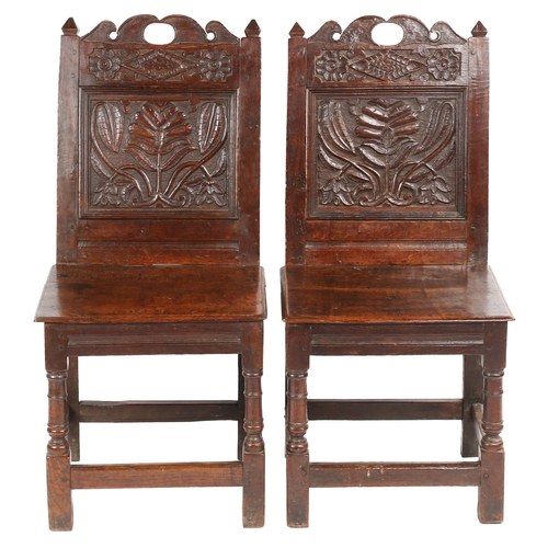 491 - A pair of Charles II oak backstools, Lancashire, circa 1670

 Each with a fully-enclosed back having... 