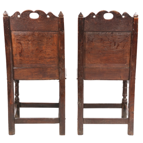 491 - A pair of Charles II oak backstools, Lancashire, circa 1670

 Each with a fully-enclosed back having... 